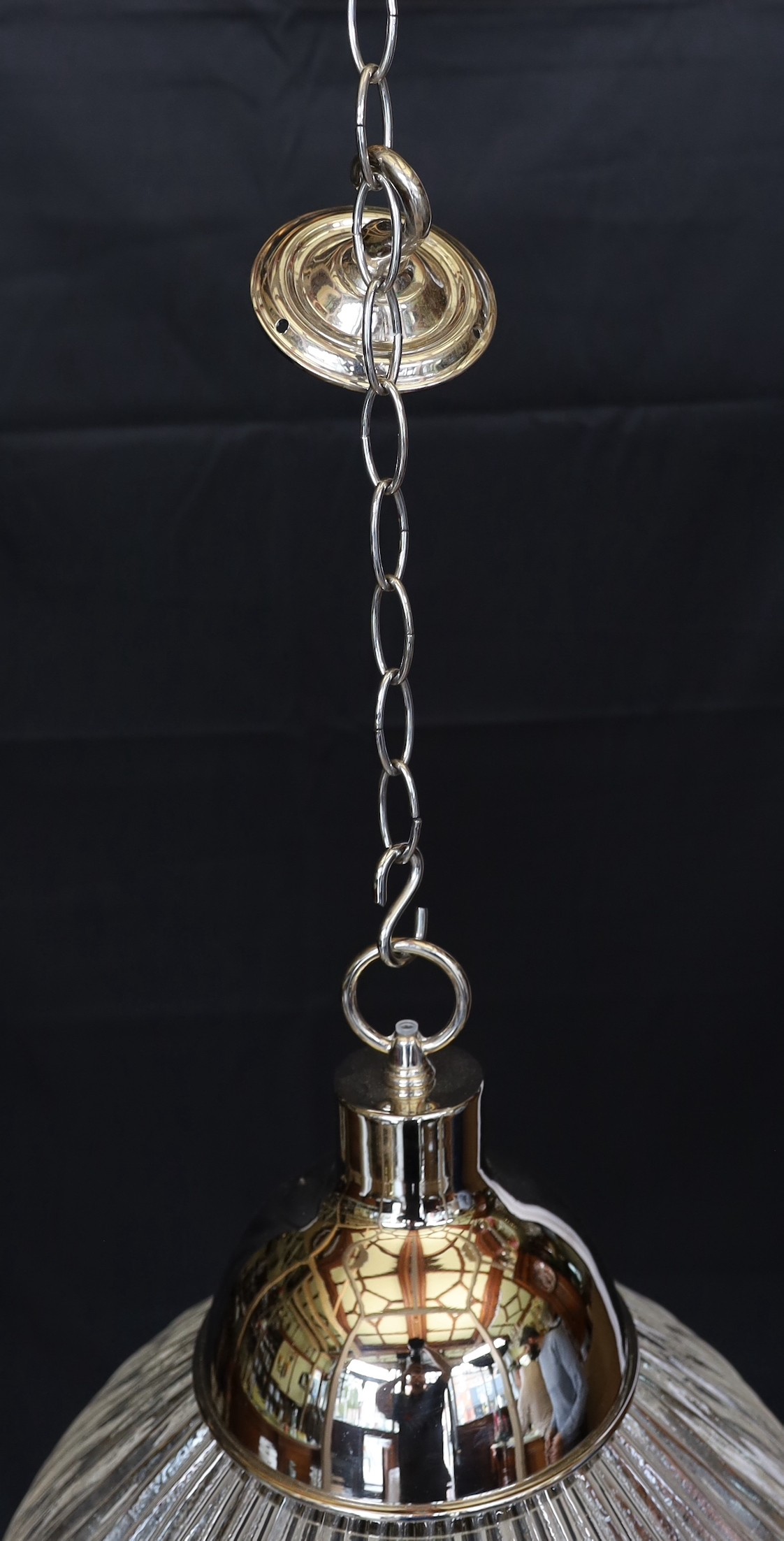 A pair of industrial style chrome plated ceiling lights with ribbed glass shades, signed Endural, diameter 46.5cm. height 50cm